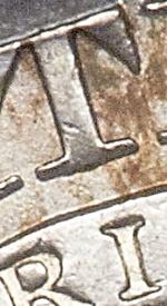 I centered under right side of stem of t 1827 capped bust half dollar